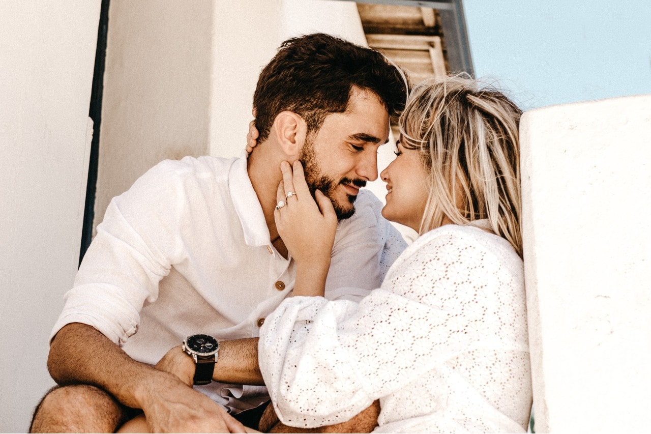 woman holding a man with trending engagement ring