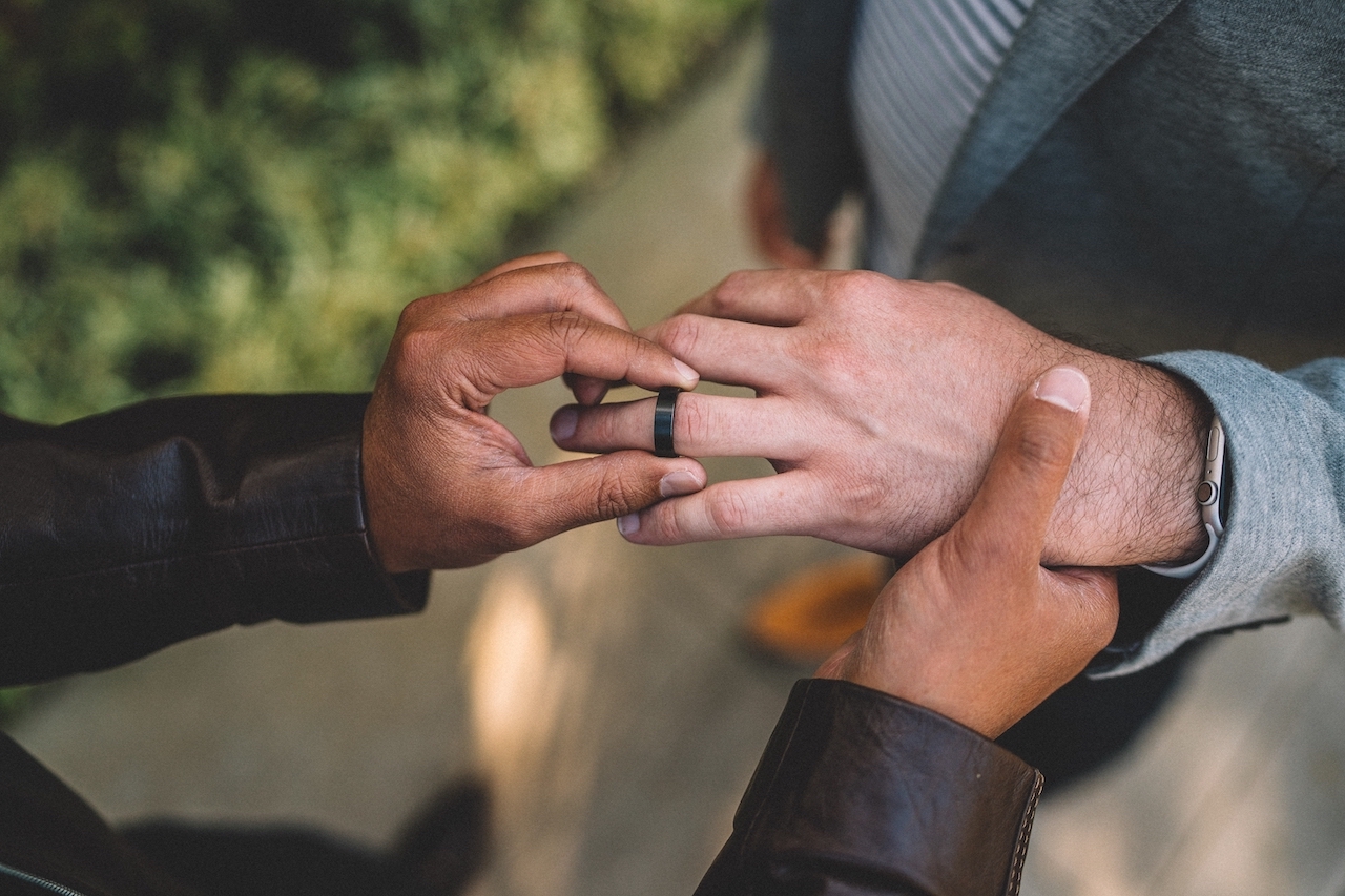 man taking off black wedding ring