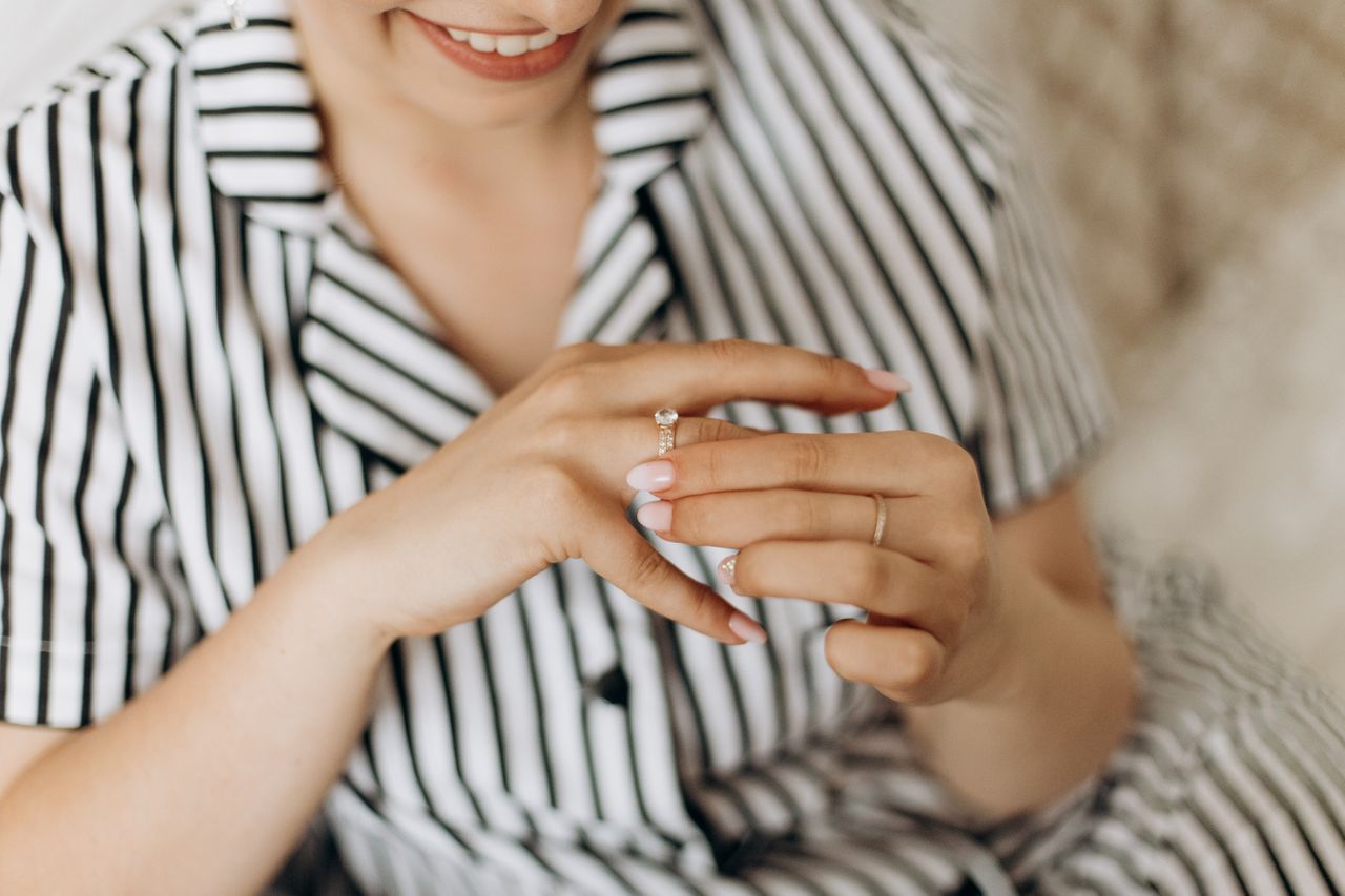 woman holding her sidestone engagement ring